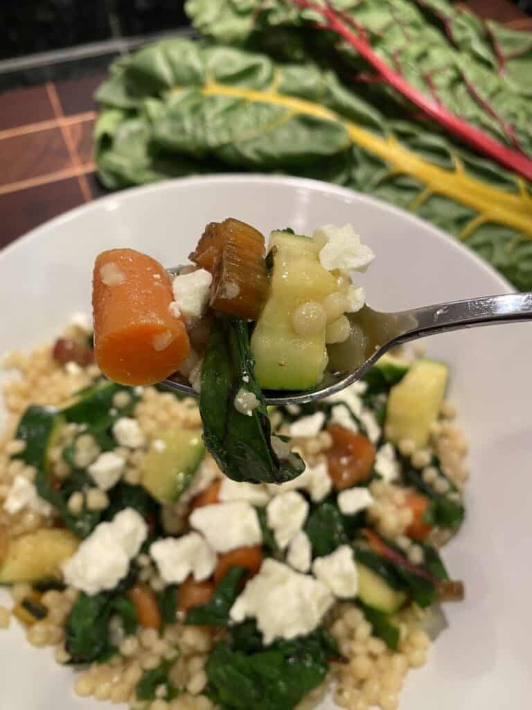 Couscous bowl with apple cider vinegar dressing and feta cheese