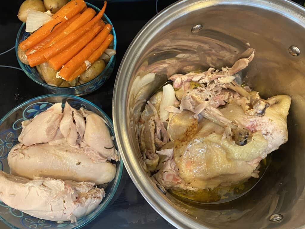 chicken carcass in pot with chicken and vegetables