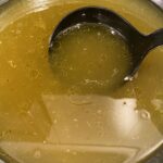 scoop of homemade chicken stock